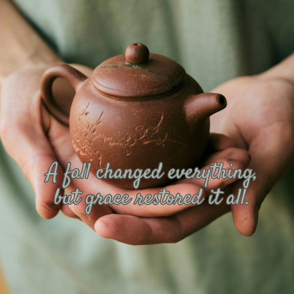 Photograph of hands gently holding a small, brown ceramic teapot with subtle floral engravings. Text overlay in soft blue cursive reads, "A fall changed everything, but grace restored it all," conveying a message of recovery and hope.