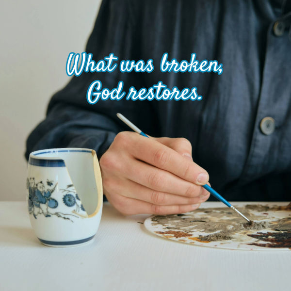 Photograph showing a person repairing a broken ceramic cup using a fine brush, illustrating the concept of restoration. Text overlay in blue cursive font reads, "What was broken, God restores," emphasizing healing and renewal.