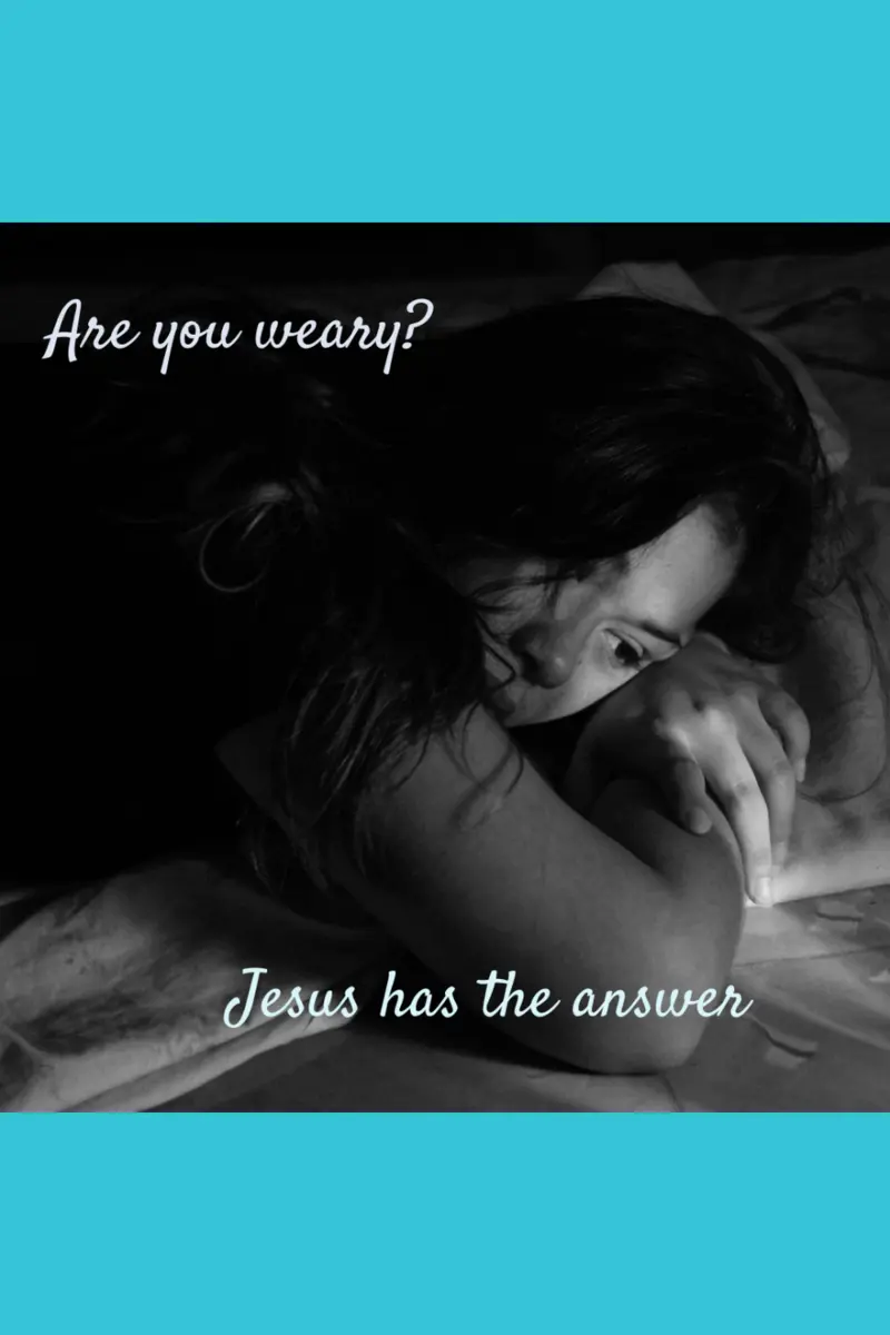 A young woman lying on her stomach on her bed, looking pensive. Are you weary? Jesus has the answer.
