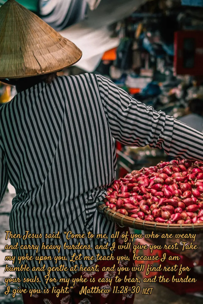 Don't you find it comforting that you can trust a God who cares about your weariness and does not find it burdensome? A woman in a straw hat carries a large platter with fruit through an outdoor market.
